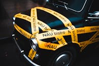 Old fashioned black car decorated with yellow adhesive tape