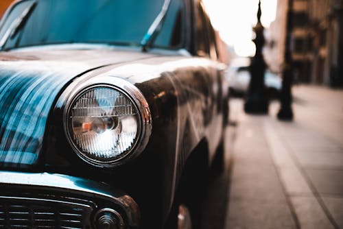 Vintage car with round shape headlights on street