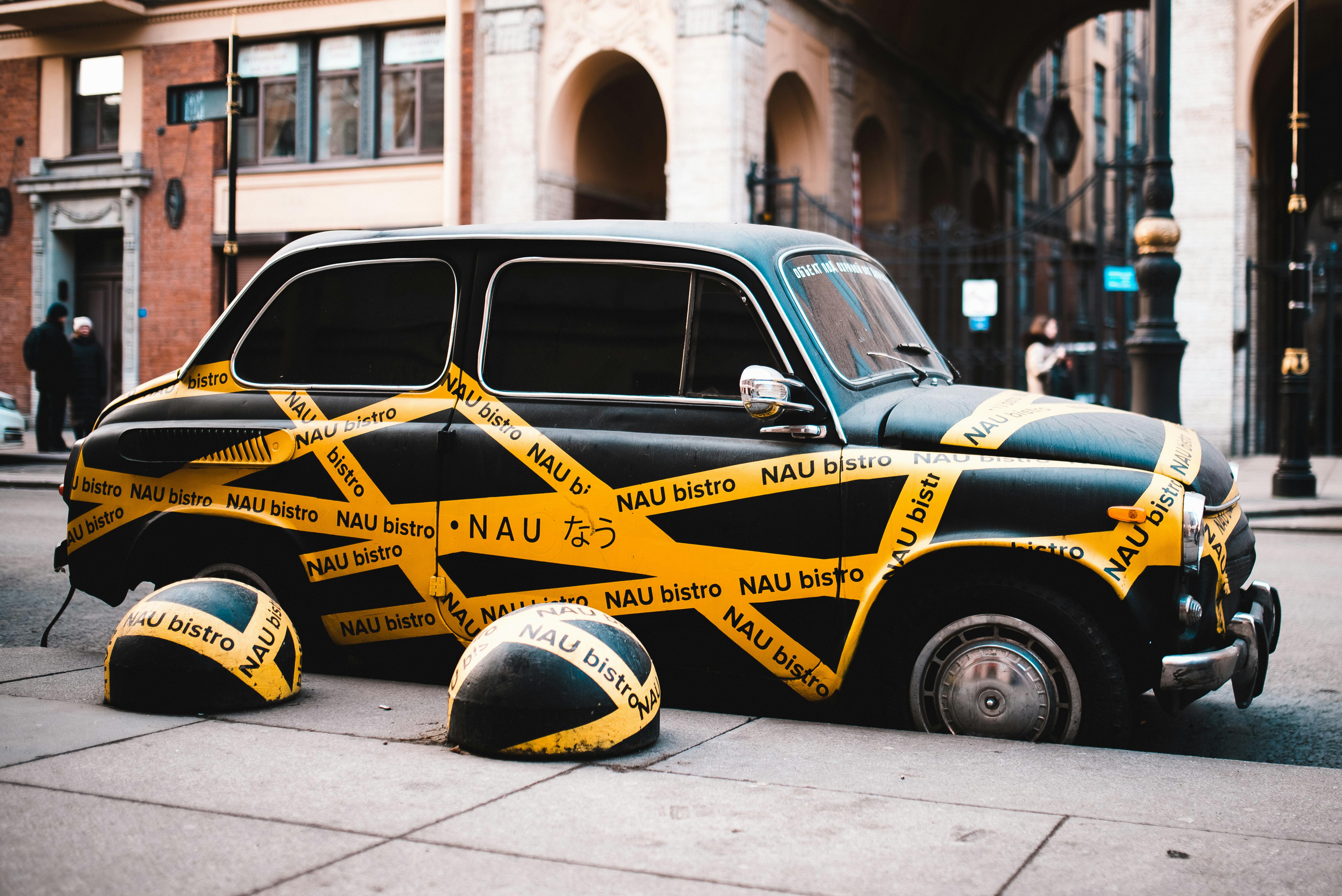 retro car of delivery in yellow adhesive tape on road