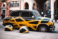 Retro car of delivery in yellow adhesive tape on road