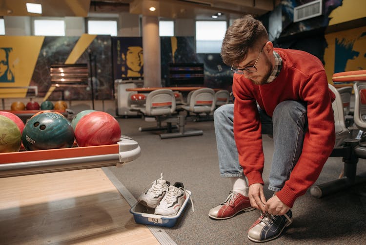 A Man Tying His Bowling Shoe