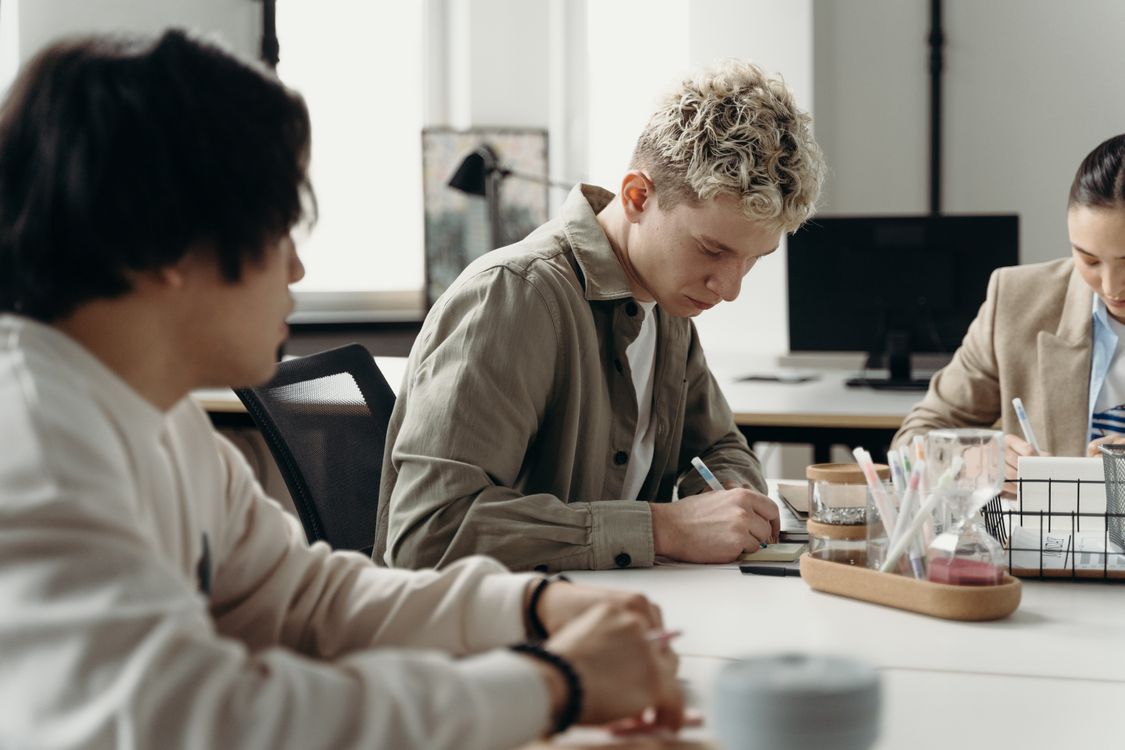 People Writing on a Notepad · Free Stock Photo