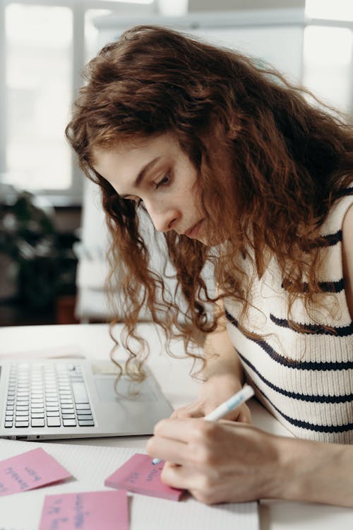 Woman in Black and White Top Writing