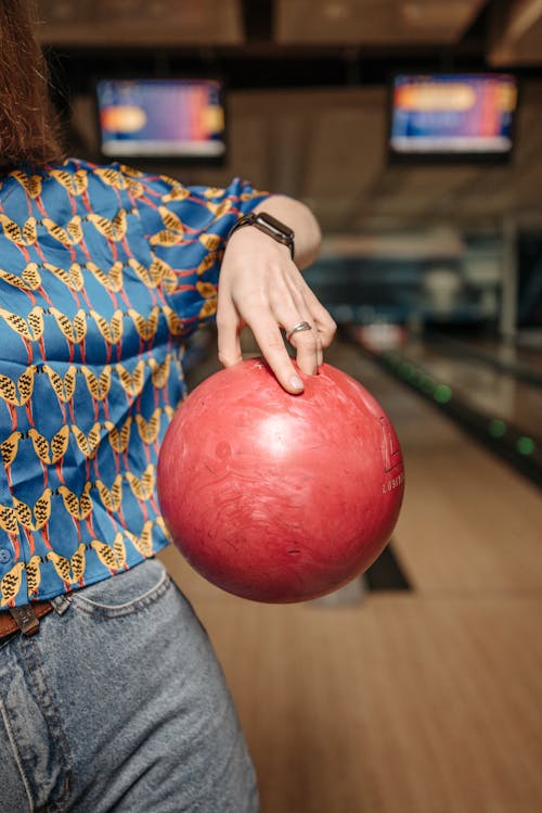 Person Holding Red Bowling Ball