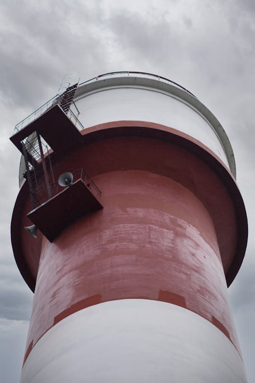 Low-Angle Shot of a Red and White Light house