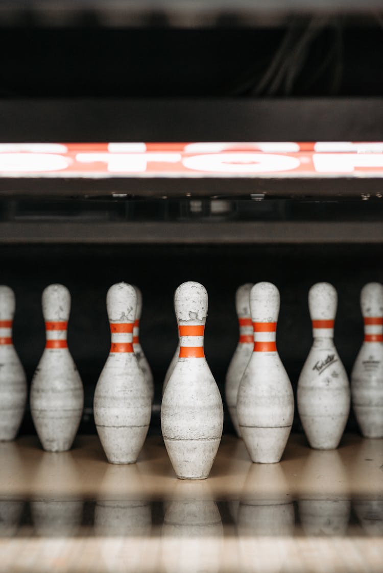 Close-Up Shot Of White And Red Bowling Pins