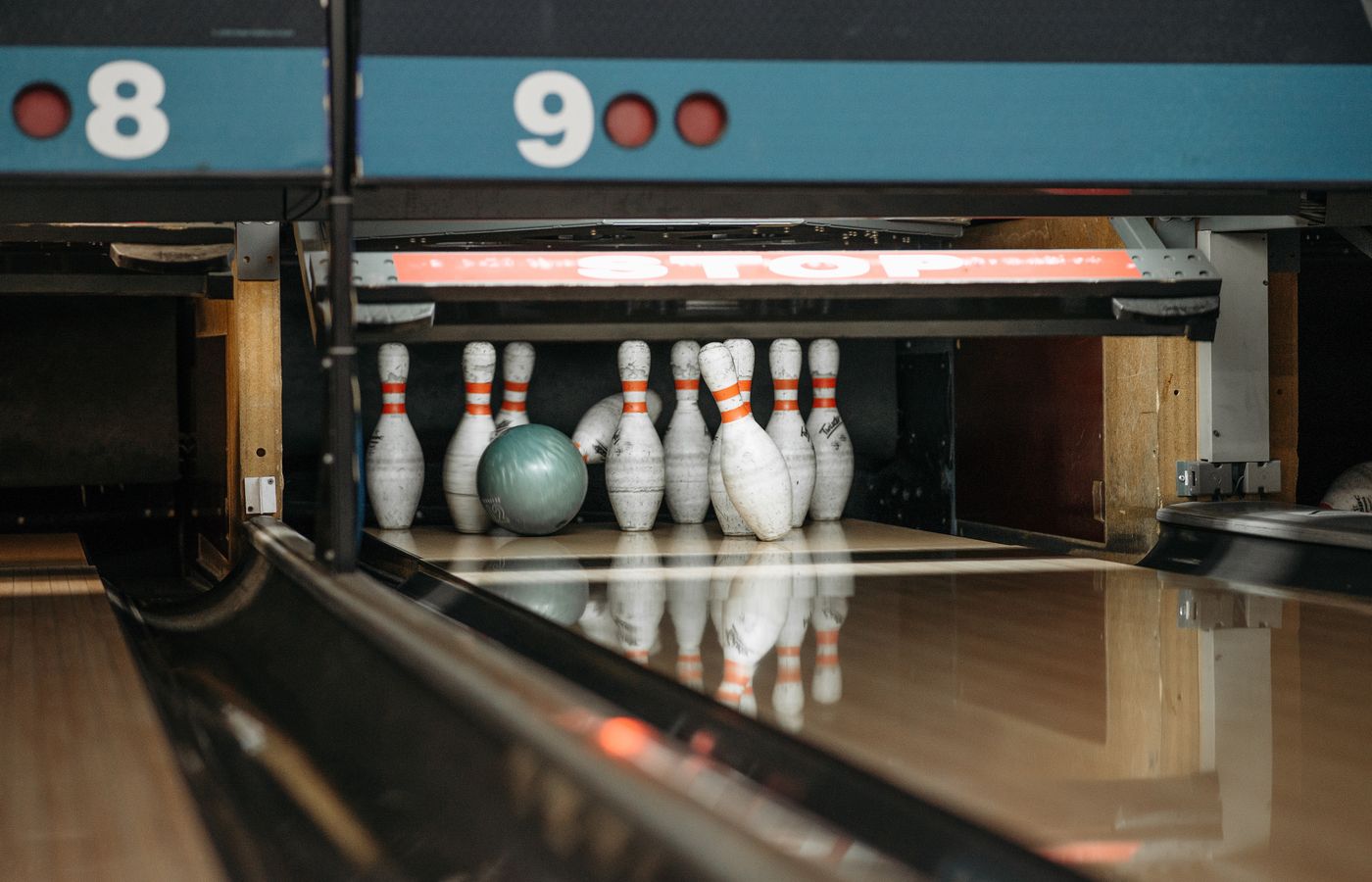 A bowling ball ready to knock down pins at a lively bowling alley.