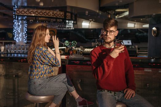Friends Drinking Alcoholic Beverages at the Bar Counter