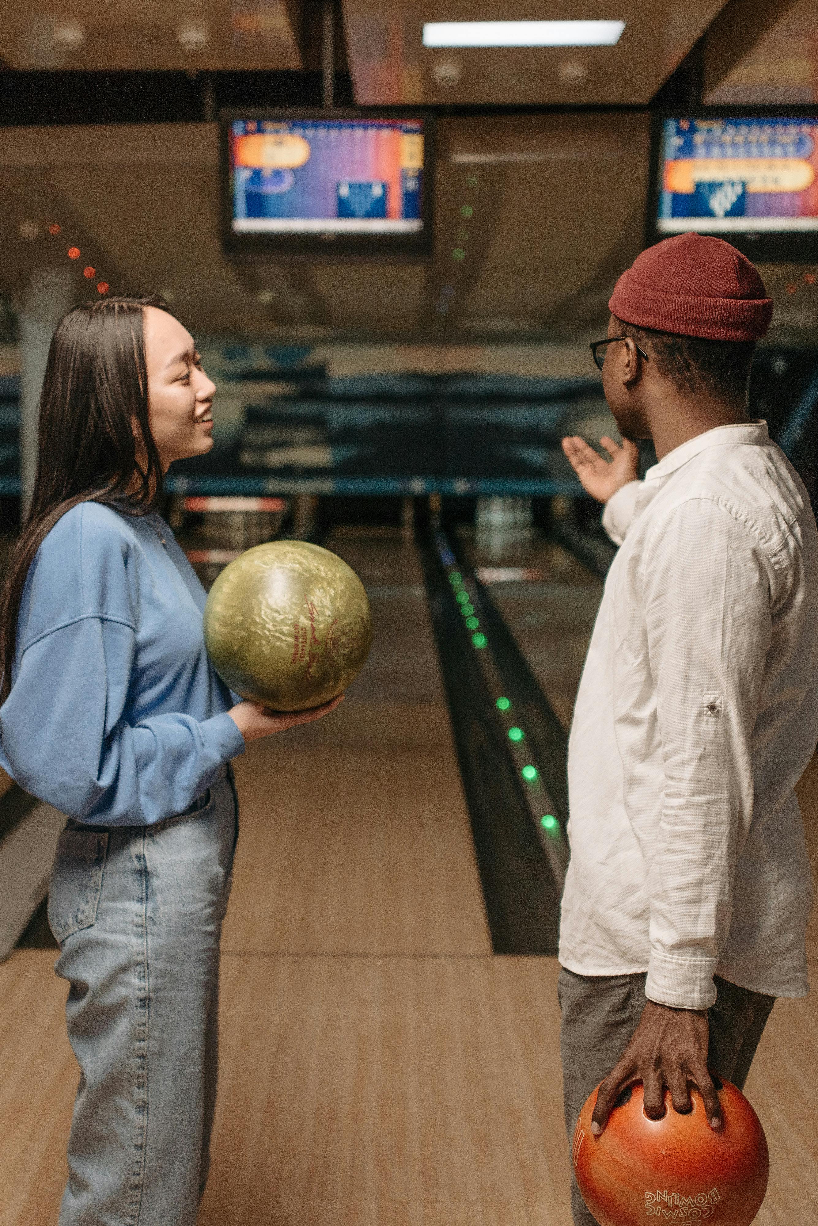 friends holding bowling balls