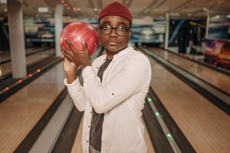 Man With Black Frame Eyeglasses Holding Red Bowling Ball