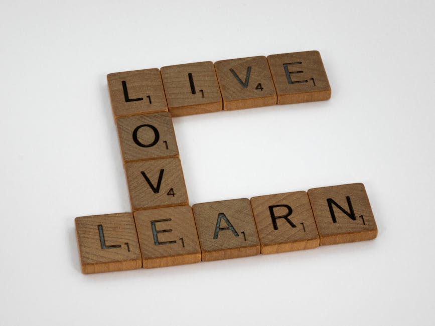 Scrabble tiles arranged to spell Live Love Learn on a white background.