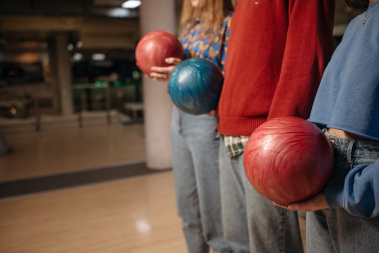 Group Of People Standing Side By Side Holding Bowling Balls