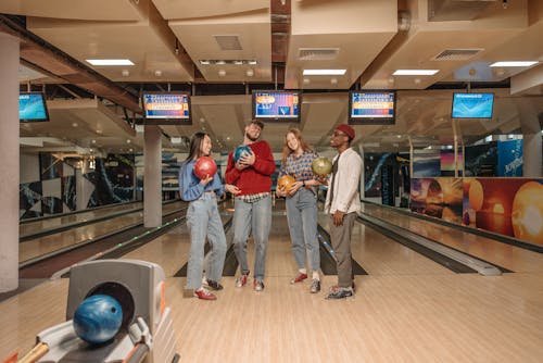 People Holding Bowling Balls