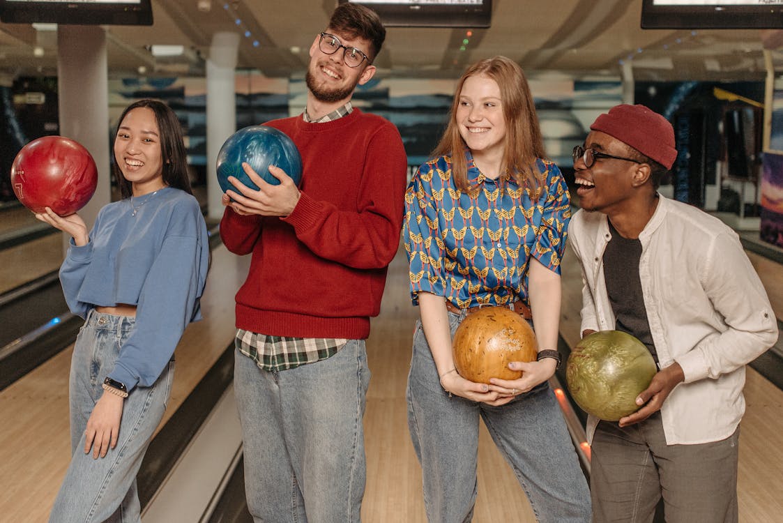 Free Close-Up Shot of a Group of Friends Holding Bowling Balls Stock Photo