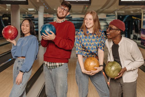Free Close-Up Shot of a Group of Friends Holding Bowling Balls Stock Photo