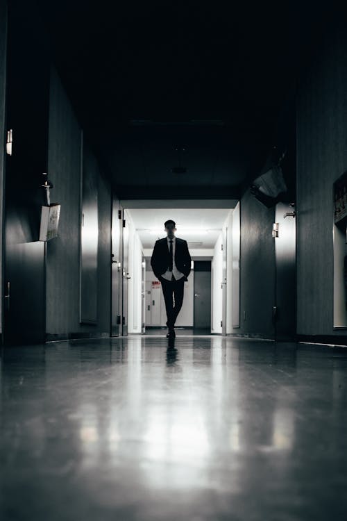 A Man Walking in the Hallway