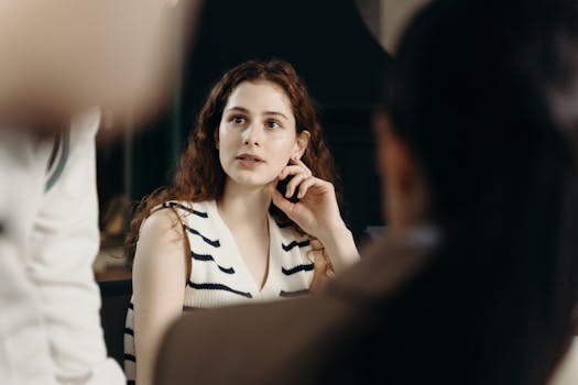 Young businesswoman attentively listening during a meeting in a modern office.