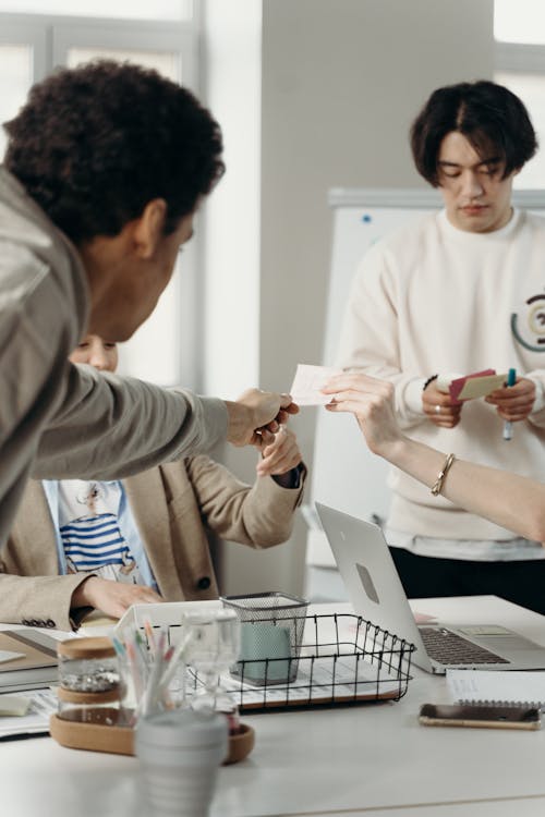 People Holding a Small Paper