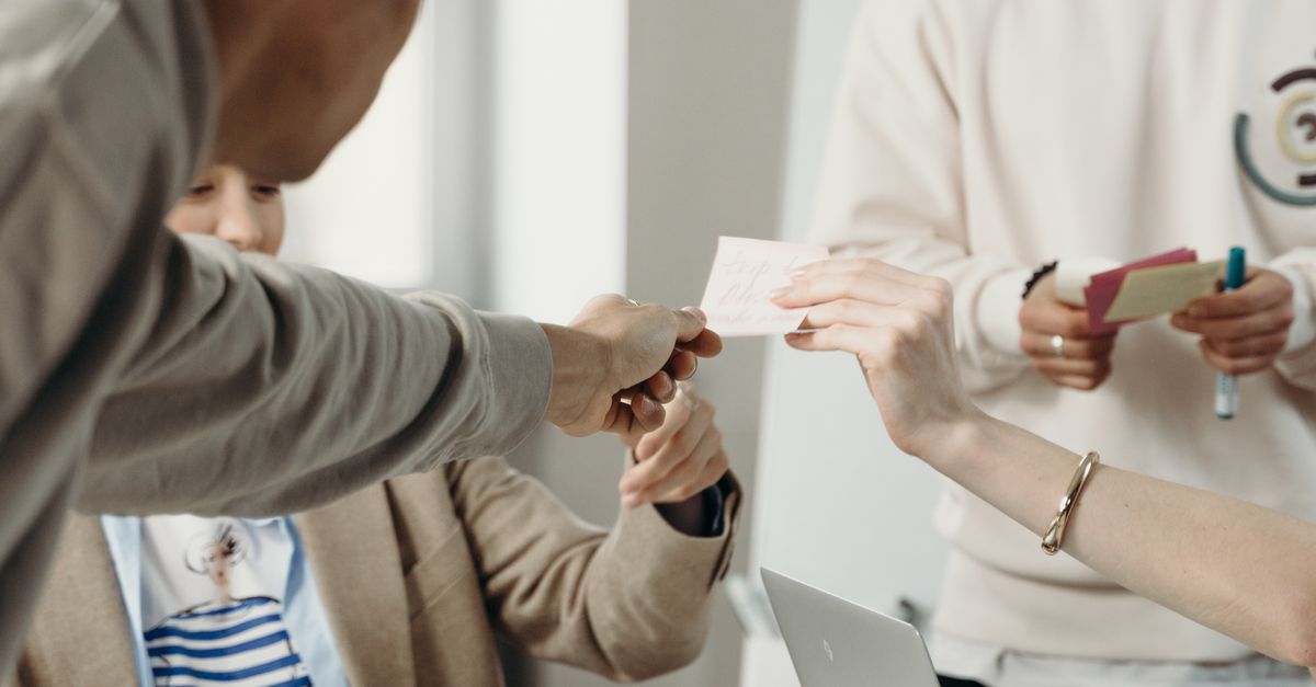 People Hold Paper People Holding a Small Paper · Free Stock Photo