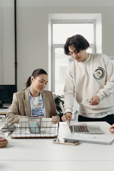 Diverse professionals engage in teamwork and project planning in a bright modern office setting.