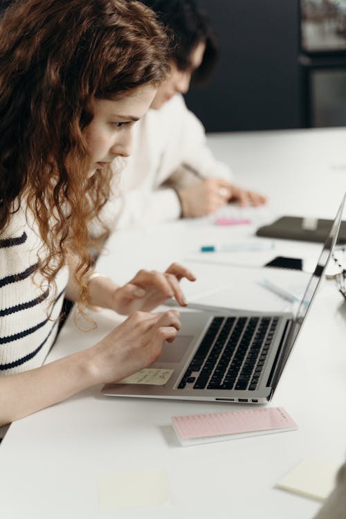 Woman Typing on a Laptop