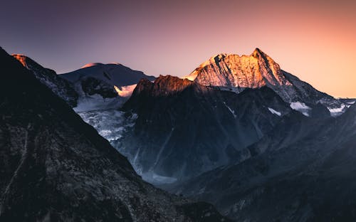 Aerial Photography of Snow-Covered Mountains during Sunrise