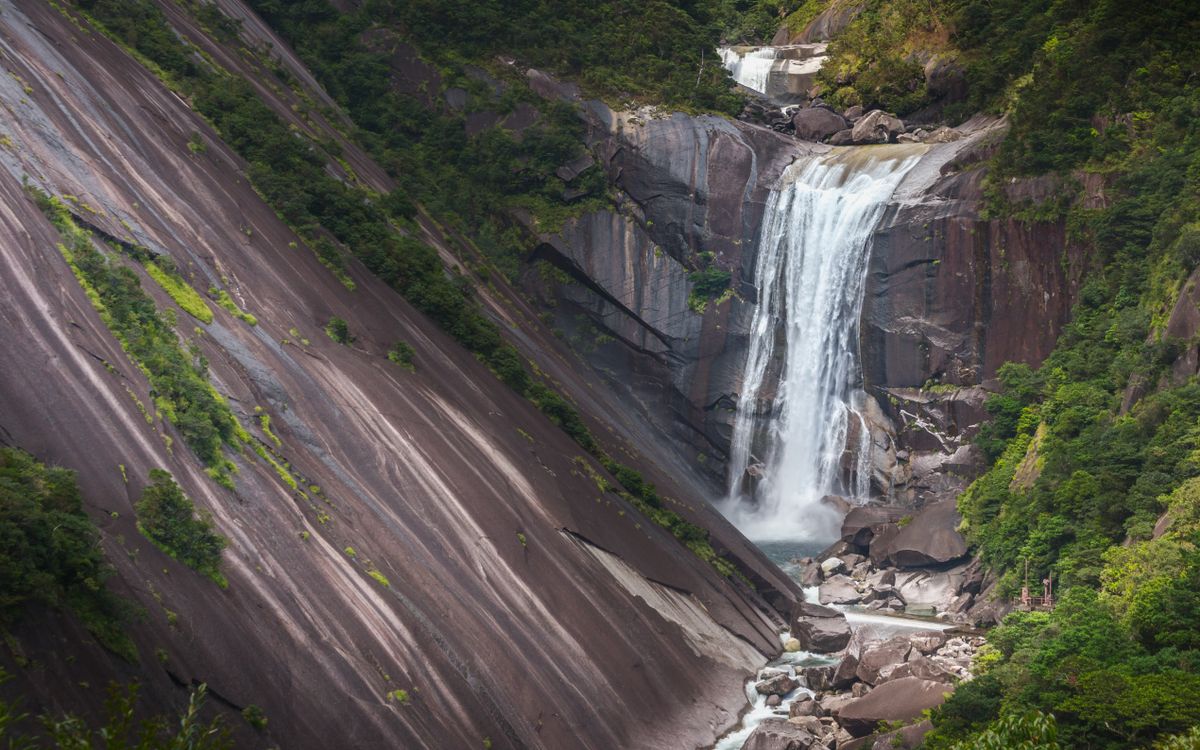 Senpiro-no-taki waterfall cascading down enormous granite rock faces on Yakushima Island