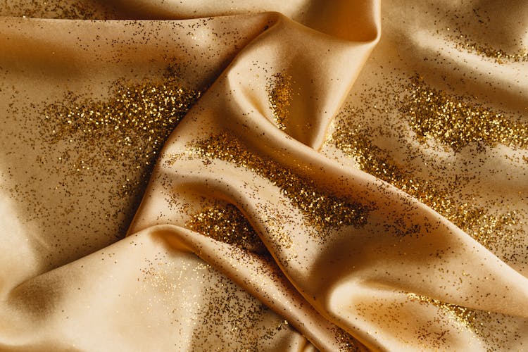 A Gold Glitters On A Silk Fabric