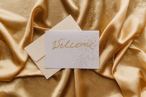 Free Card on Top of a Gold Fabric Stock Photo