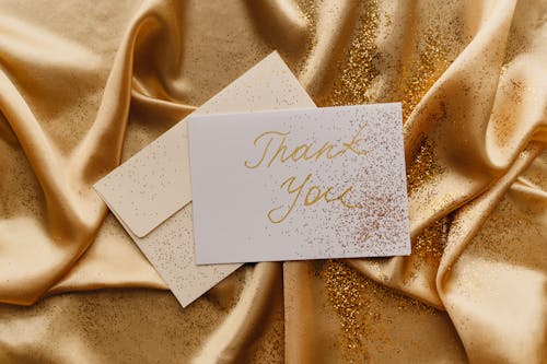 Free Card on a Gold Fabric Stock Photo