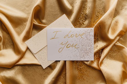 Card on Top of a Gold Fabric