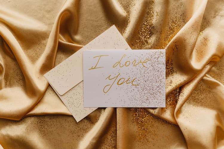 Card On Top Of A Gold Fabric