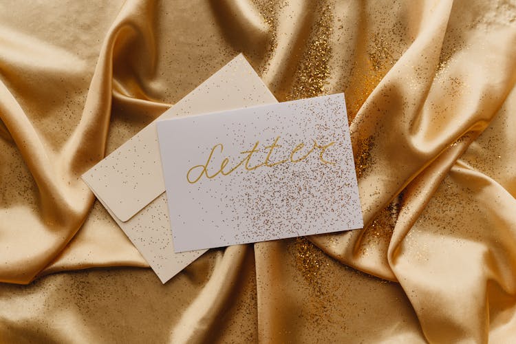 White Card On A Gold Fabric