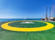 Green and Yellow Helipad Under the Blue Sky