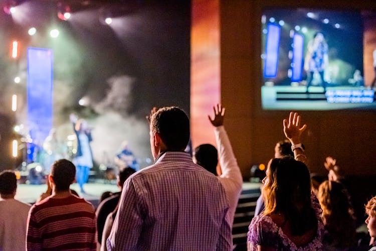 People Raising Their Hands During A Live Performance