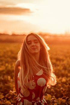 Portrait of a woman in a polka dot dress enjoying sunset in a field in Brazil.