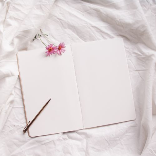 A plain open field notebook on linen — photo by Elisabeth Ende on Pexels