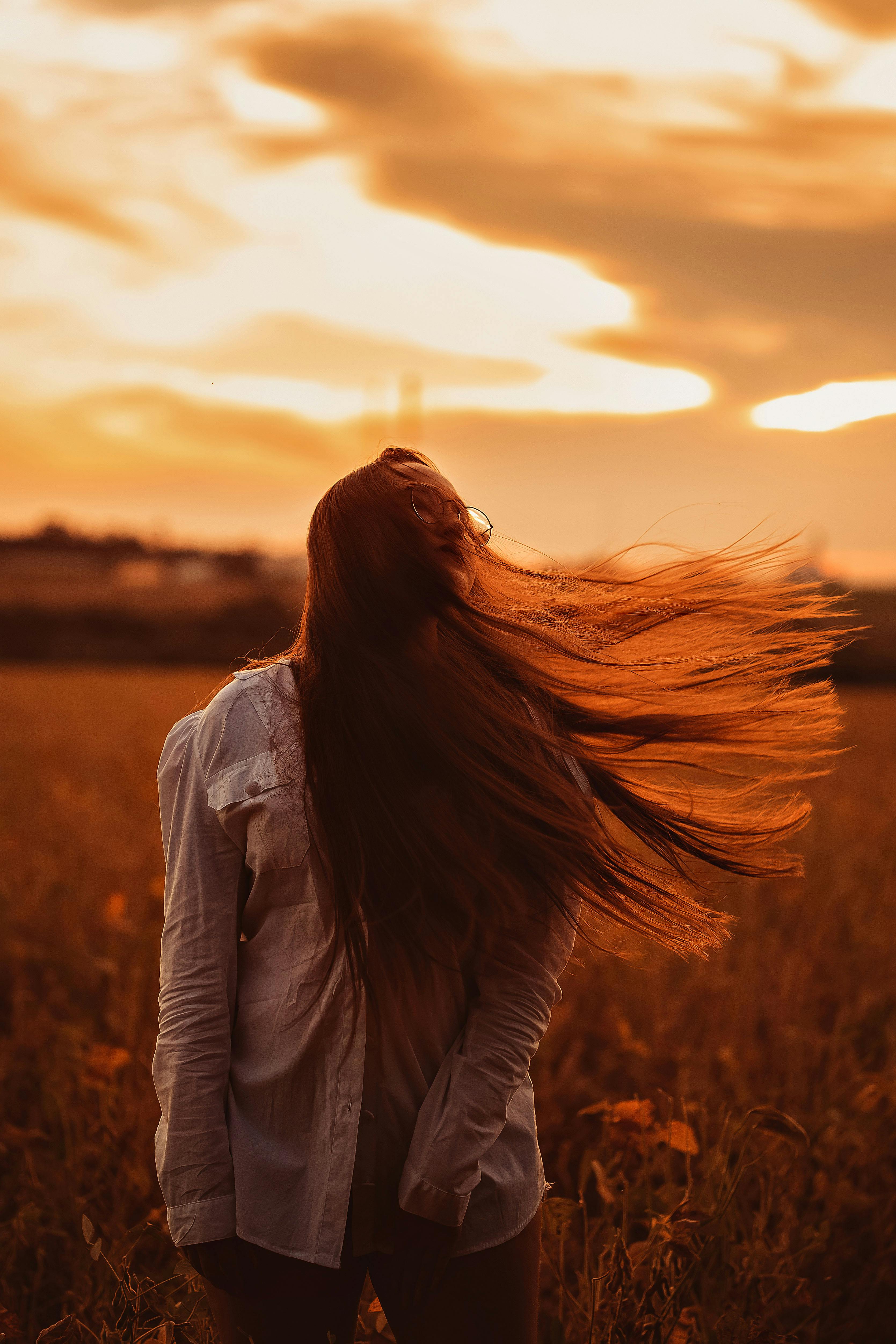 A Woman Standing with Long Hair · Free Stock Photo