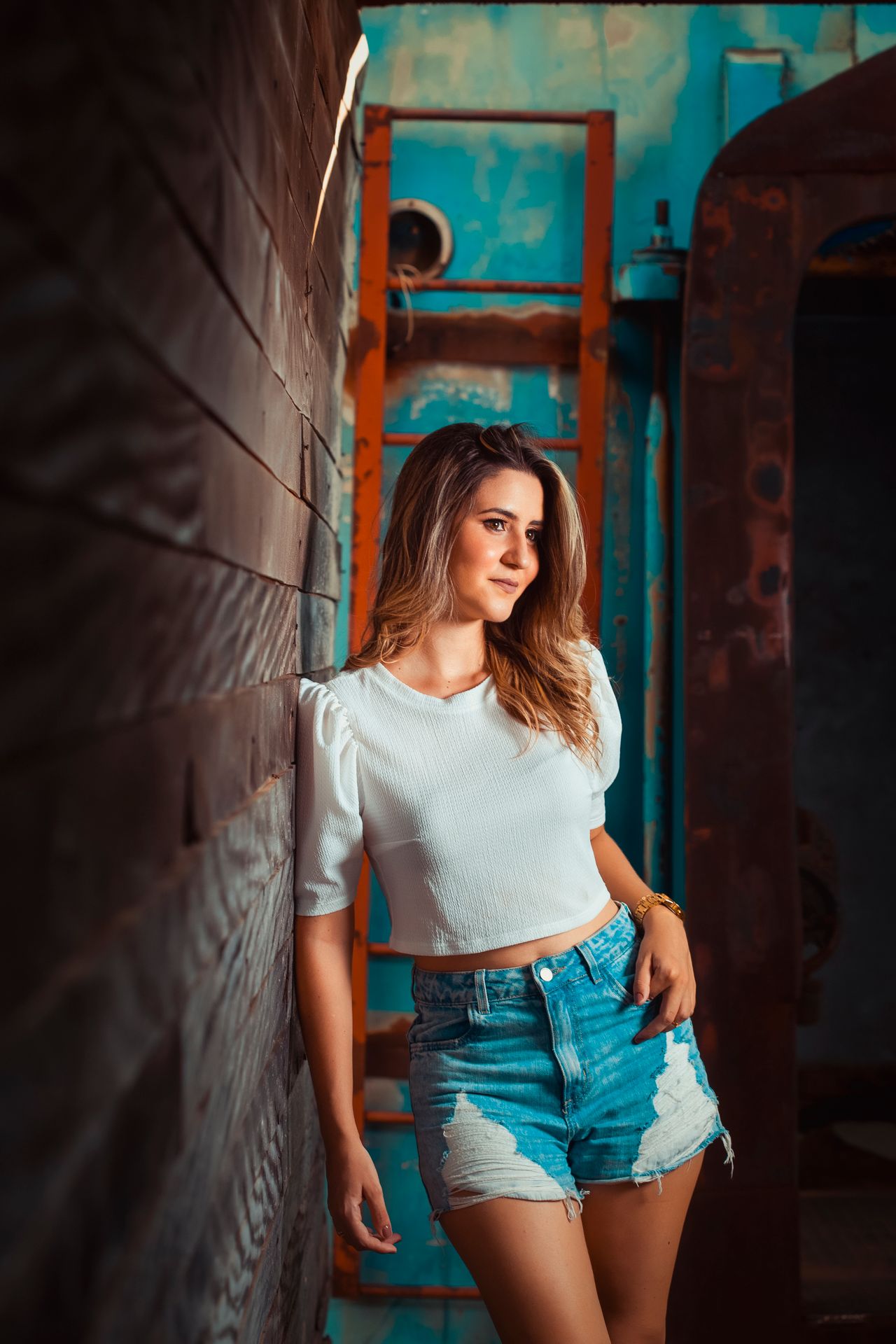 Woman in a white puff-sleeve top and distressed denim shorts