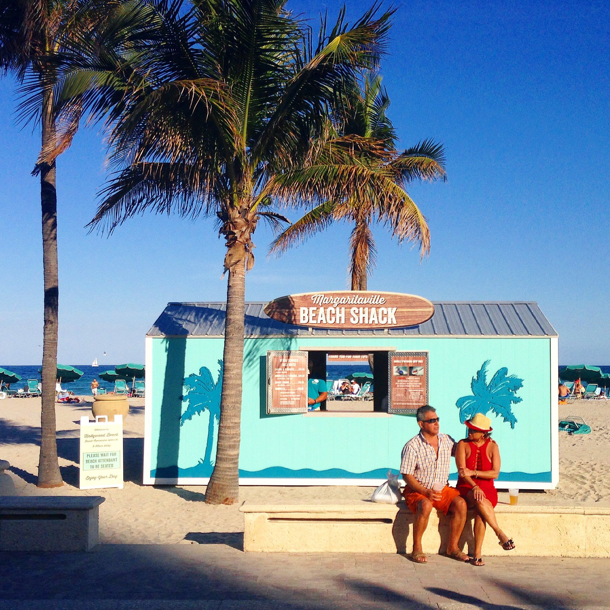 A couple enjoys a sunny day by Margartivaville Beach Shack in Hollywood, Florida.