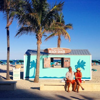 A couple enjoys a sunny day by Margartivaville Beach Shack in Hollywood, Florida.