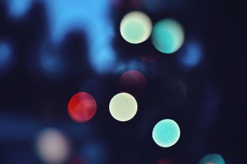 Free Colorful bokeh circles create an artistic abstract effect against a dark backdrop. Stock Photo