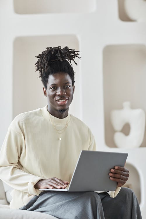 Smiling Man Using a Laptop