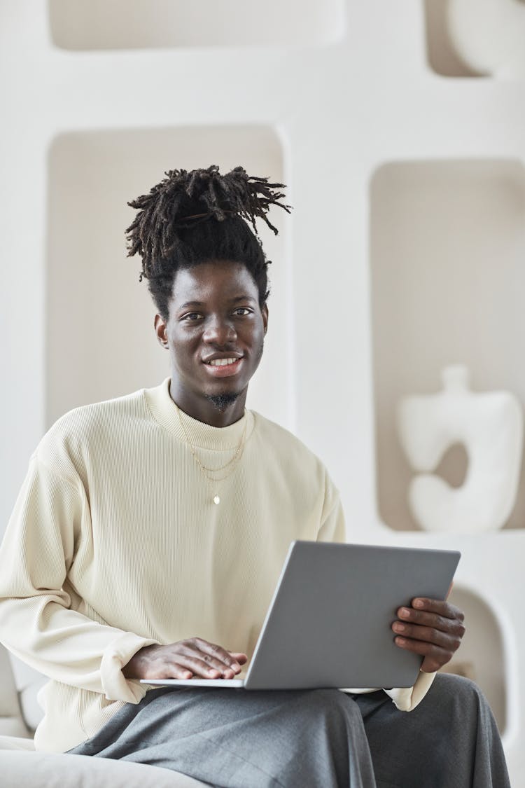 Smiling Man Using A Laptop