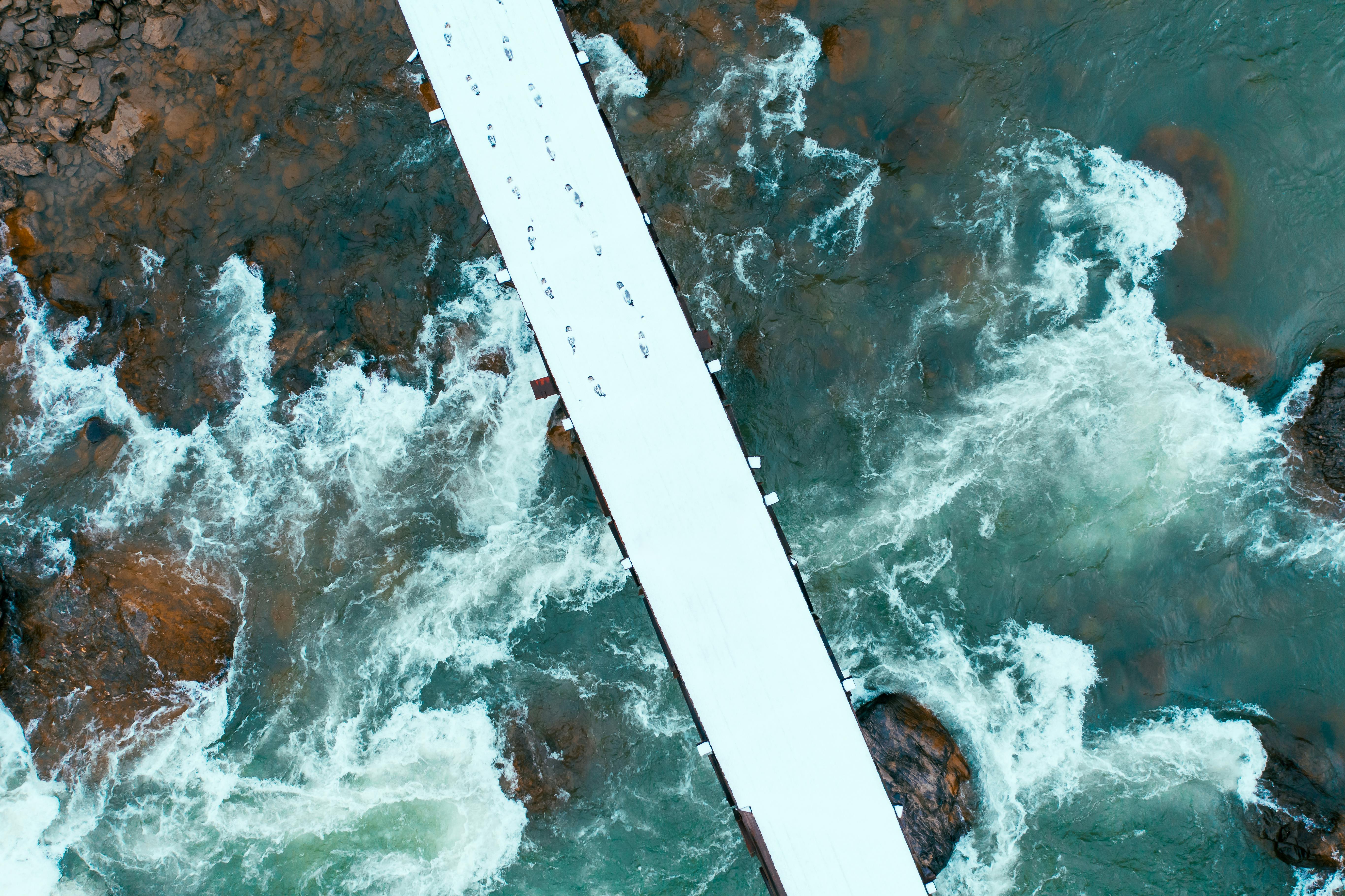 white and brown wooden plank on water