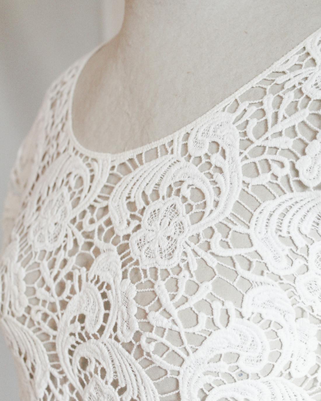 Ivory lace princess-cut blouse displayed on a mannequin with curved seams