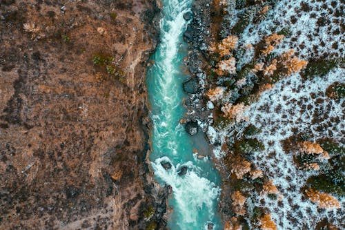 An Aerial Shot of a Cascading River during Winter