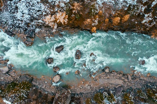 An Aerial Shot of a Cascading River during Winter