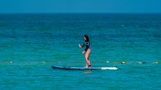 Faceless woman on SUP paddleboard