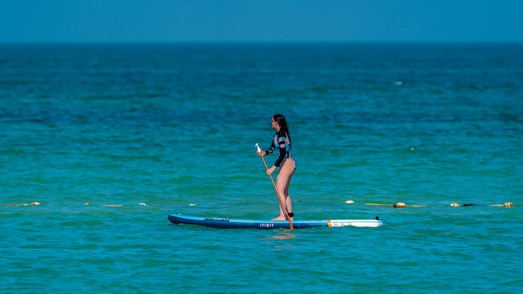 Faceless Woman On SUP Paddleboard